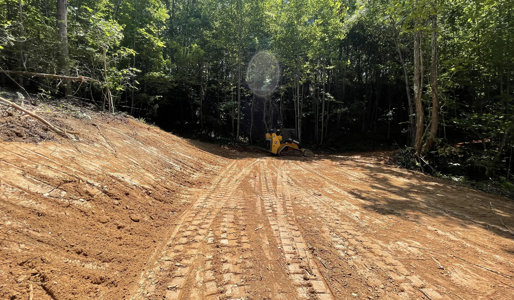 Access road and wooded path clearing with equipment in Cherokee County Georgia